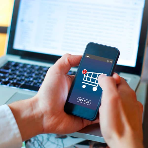 Close up of a man's hands adding an item to a online shop cart on a cellphone